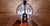 View of the interior of a wooden sauna room with benches and a glass door.